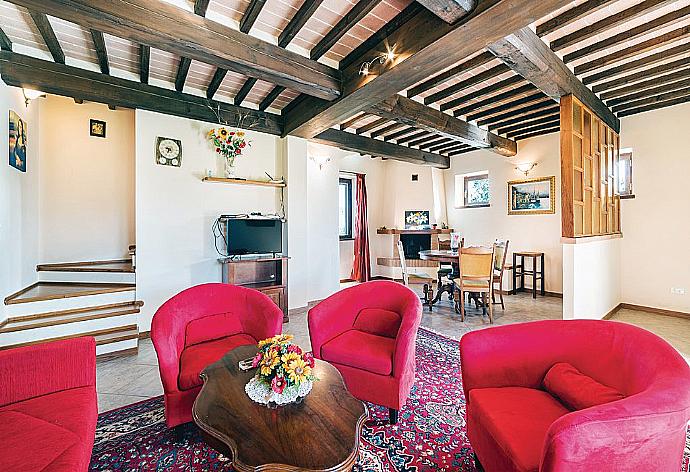 Open-plan living room with sofas, DVD player and dining area. . - Villa San Lorenzo . (Galleria fotografica) }}