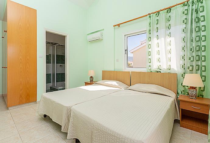 Twin bedroom with en suite bathroom, A/C, and balcony access . - Villa Coral Aura . (Photo Gallery) }}