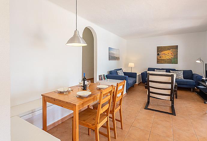 Open-plan living room with sofas, dining area, kitchen, WiFi internet, satellite TV, and terrace access . - Villa Binibety . (Fotogalerie) }}