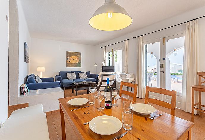 Open-plan living room with sofas, dining area, kitchen, WiFi internet, satellite TV, and terrace access . - Villa Binibety . (Fotogalerie) }}