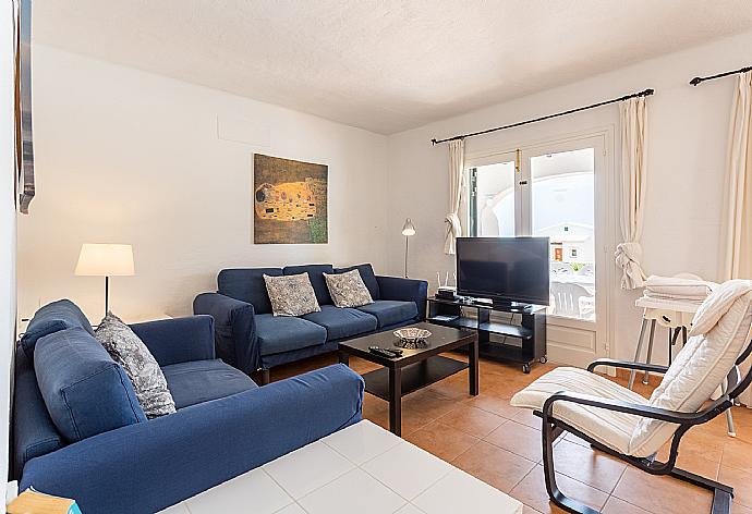 Open-plan living room with sofas, dining area, kitchen, WiFi internet, satellite TV, and terrace access . - Villa Binibety . (Galleria fotografica) }}