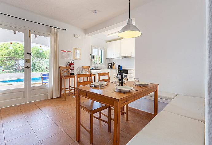 Open-plan living room with sofas, dining area, kitchen, WiFi internet, satellite TV, and terrace access . - Villa Binibety . (Galería de imágenes) }}