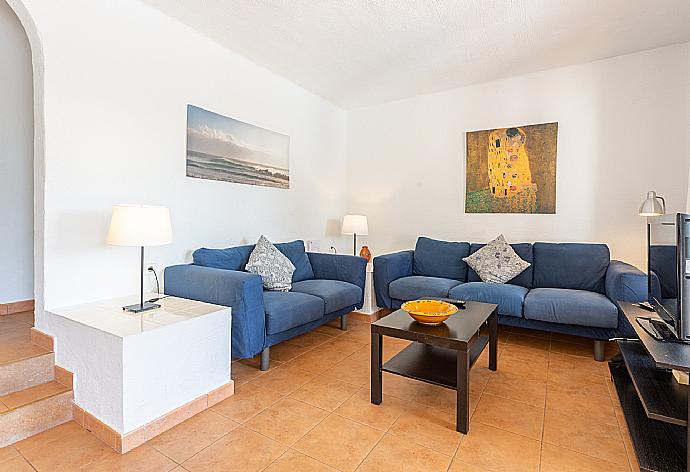 Open-plan living room with sofas, dining area, kitchen, A/C, WiFi internet, satellite TV, and terrace access . - Villa Binimary . (Fotogalerie) }}