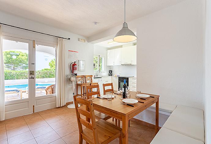 Open-plan living room with sofas, dining area, kitchen, A/C, WiFi internet, satellite TV, and terrace access . - Villa Binimary . (Galerie de photos) }}