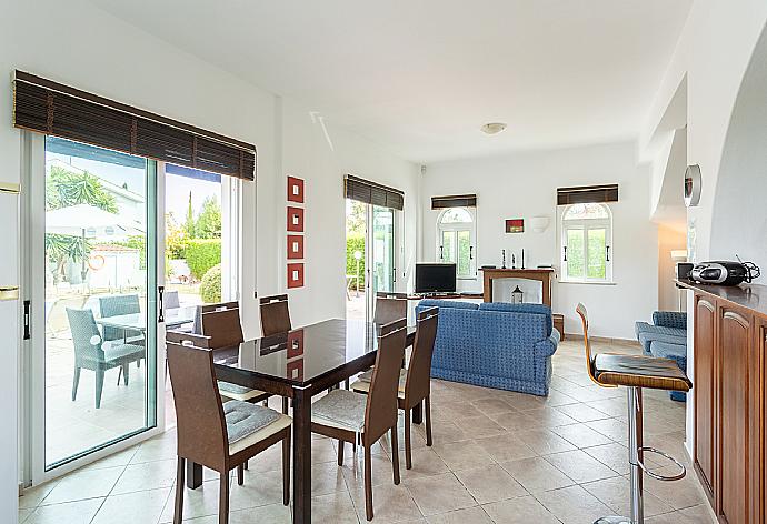 Open-plan living room with sofas, dining area, kitchen, ornamental fireplace, WiFi internet, satellite TV, and pool terrace access . - Villa Cleopatra . (Fotogalerie) }}