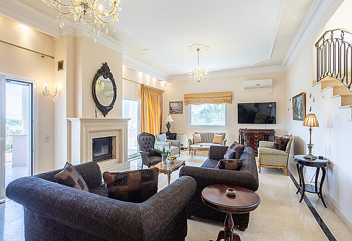 Living room with sofas, dining area, ornamental fireplace, A/C, WiFi internet, and satellite TV, and terrace access . - Villa Denise . (Photo Gallery) }}