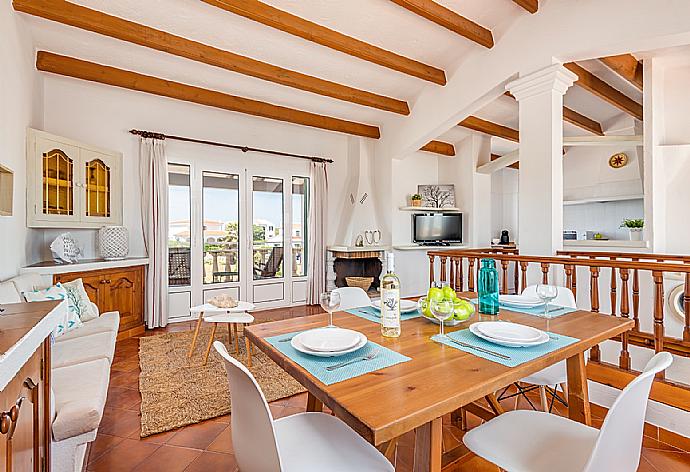 Living room with sofas, dining area, ornamental fireplace, WiFi internet, satellite TV, DVD player, and terrace access . - Villa Miguels . (Galería de imágenes) }}