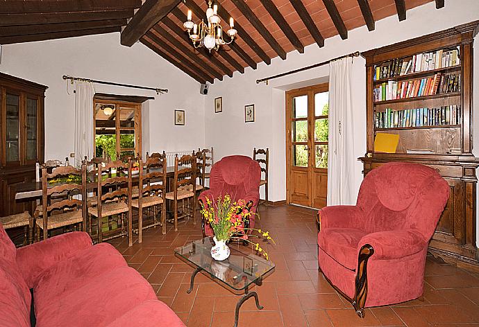 Living room with sofas, dining area, ornamental fireplace, and satellite TV . - Villa Piombona . (Галерея фотографий) }}