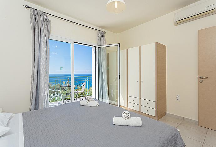 Double bedroom with en suite bathroom, A/C, and upper terrace access with panoramic sea views . - Villa Georgia . (Photo Gallery) }}