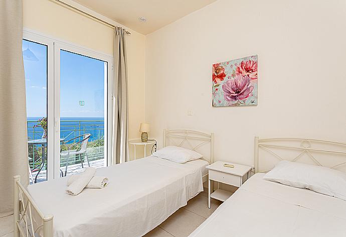 Twin bedroom with en suite bathroom, A/C, and upper terrace access with panoramic sea views . - Villa Georgia . (Photo Gallery) }}