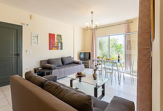 Open-plan living room with sofas, dining area, kitchen, A/C, WiFi internet, and satellite TV  . - Villa Eri . (Galleria fotografica) }}