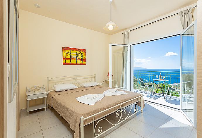 Double bedroom with en suite bathroom, A/C, and upper terrace access with panoramic sea views . - Villa Eri . (Photo Gallery) }}