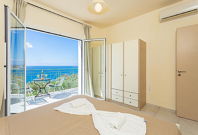 Double bedroom with en suite bathroom, A/C, and upper terrace access with panoramic sea views . - Villa Eri . (Photo Gallery) }}