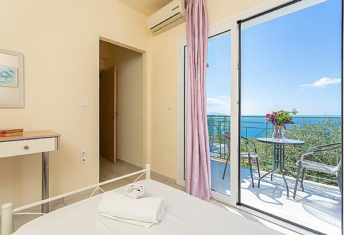 Twin bedroom with en suite bathroom, A/C, and upper terrace access with panoramic sea views . - Villa Eri . (Photo Gallery) }}