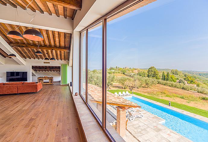 Living room on first floor with sofas, kitchenette, satellite TV, and panoramic views . - Villa Il Girasole . (Photo Gallery) }}