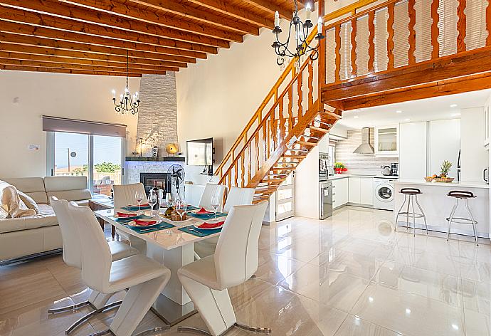 Open-plan living room with sofas, dining area, kitchen, ornamental fireplace, mezzanine, WiFi internet, and TV . - Villa Stone House . (Galería de imágenes) }}