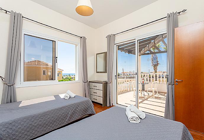 Twin bedroom with en suite bathroom, A/C, and upper terrace access with sea views . - Queens Paradise 1 . (Photo Gallery) }}