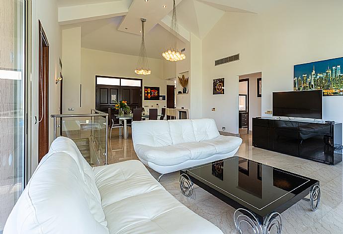 Open-plan living room with sofas, dining area, kitchen, ornamental fireplace, A/C, WiFi internet, satellite TV, and sea views . - Villa Galene . (Photo Gallery) }}