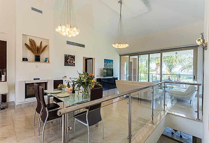 Open-plan living room with sofas, dining area, kitchen, ornamental fireplace, A/C, WiFi internet, satellite TV, and sea views . - Villa Galene . (Photo Gallery) }}