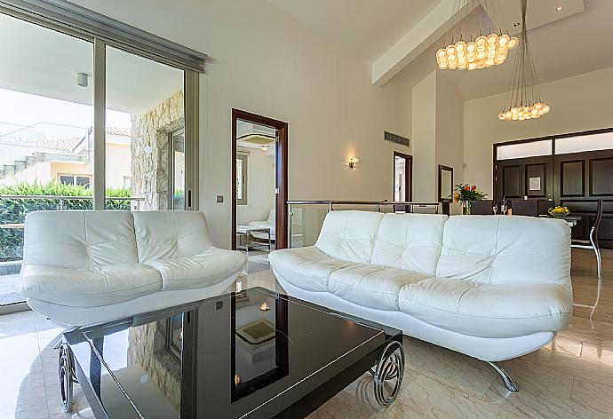 Open-plan living room with sofas, dining area, kitchen, ornamental fireplace, A/C, WiFi internet, satellite TV, and sea views . - Villa Galene . (Photo Gallery) }}