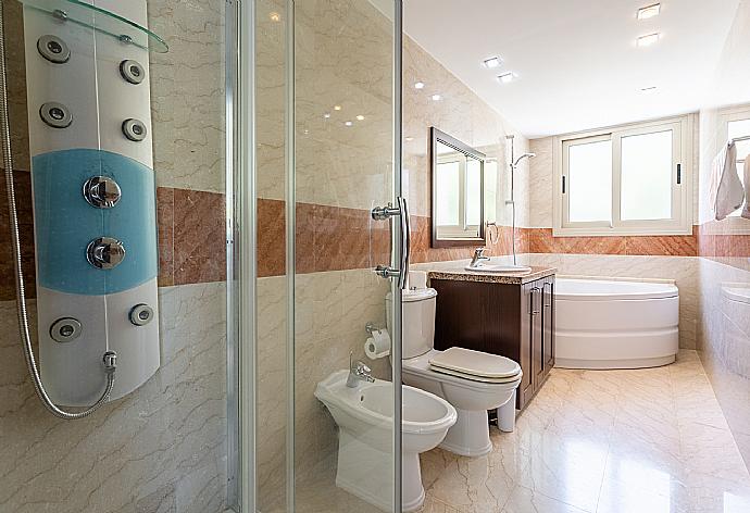 En suite bathroom with shower and spa bath . - Villa Galene . (Photo Gallery) }}