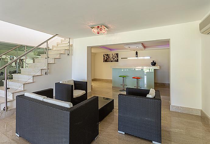 Living room on lower level with sofas, bar, jacuzzi, gym, and A/C . - Villa Galene . (Photo Gallery) }}