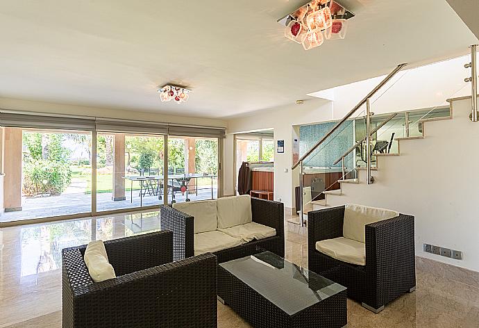 Living room on lower level with sofas, bar, jacuzzi, gym, and A/C . - Villa Galene . (Photo Gallery) }}