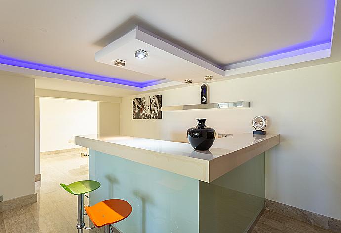 Living room on lower level with sofas, bar, jacuzzi, gym, and A/C . - Villa Galene . (Photo Gallery) }}