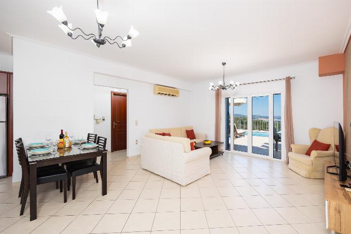 Open-plan living room with sofas, dining area, kitchen, A/C, WiFi internet, and satellite TV . - Villa Europe Ena . (Photo Gallery) }}