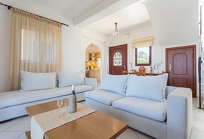 Living room with sofas, dining area, A/C, WiFi internet, and satellite TV  . - Villa Europe Thia . (Photo Gallery) }}