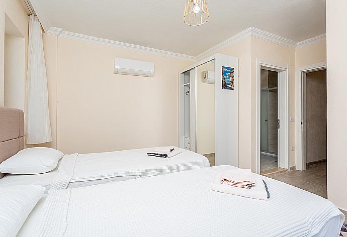 Twin bedroom with en suite bathroom, A/C, and balcony access . - Villa Veli . (Photo Gallery) }}