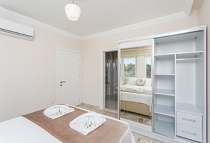 Double bedroom with en suite bathroom, A/C, and balcony access . - Villa Toprak . (Photo Gallery) }}