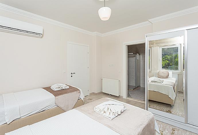 Twin bedroom with en suite bathroom and A/C . - Villa Toprak . (Photo Gallery) }}