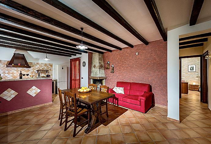 Open-plan living room with sofas, dining area, kitchen, WiFi internet, satellite TV, and terrace access . - Villa Camelia . (Fotogalerie) }}