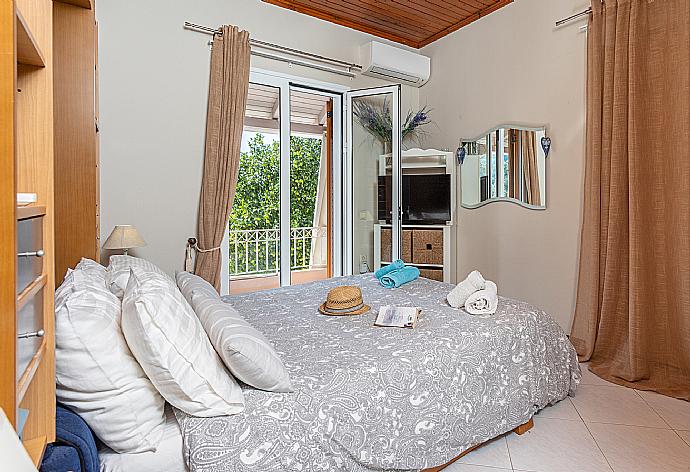 Double bedroom with A/C, TV, and balcony access . - Dimitris Cottage . (Photo Gallery) }}