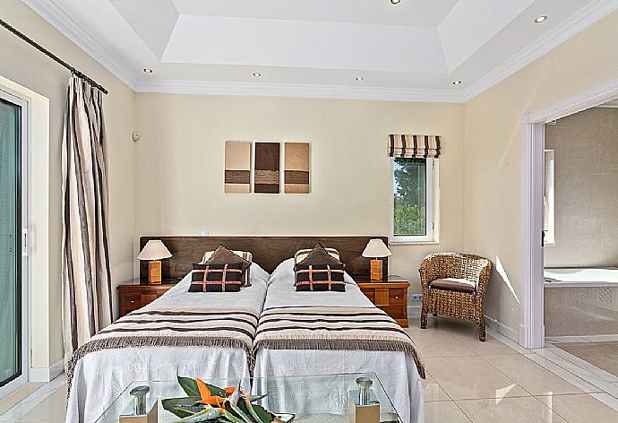 Twin bedroom with  balcony access and en-suite bathroom. . - Villa Penina . (Photo Gallery) }}