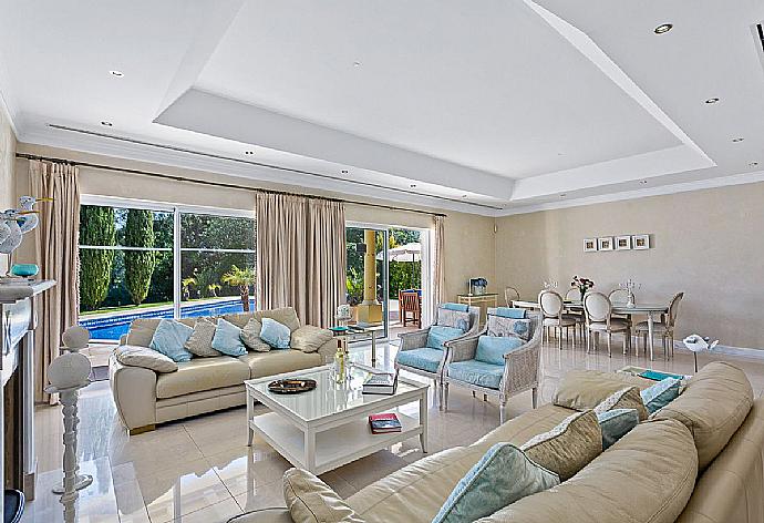 Living room with sofas ,dining area and pool access.   . - Villa Penina . (Photo Gallery) }}