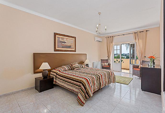 Double bedroom with AC , balcony access and en suite bathroom. . - Villa Silves . (Photo Gallery) }}