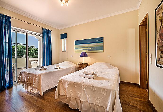 Twin bedroom with balcony access and en-suite bathroom. . - Villa Bela Vista . (Photo Gallery) }}