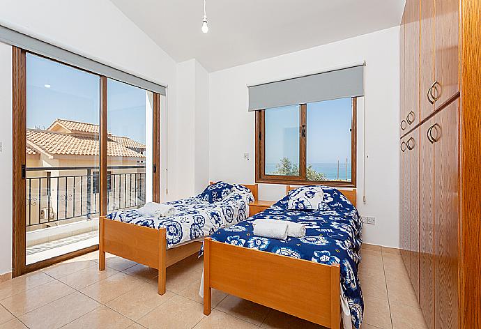 Twin bedroom with en suite bathroom, A/C, and balcony access with sea views . - Villa Sunset . (Галерея фотографий) }}