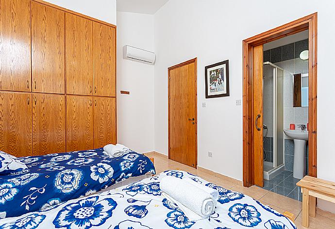 Twin bedroom with en suite bathroom, A/C, and balcony access with sea views . - Villa Sunset . (Photo Gallery) }}