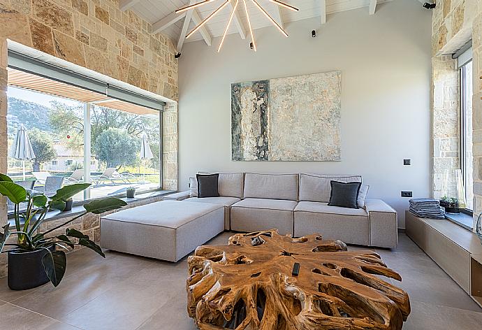 Open-plan living room with sofas, dining area, kitchen, A/C, WiFi internet, and satellite TV . - Villa Ersi . (Галерея фотографий) }}