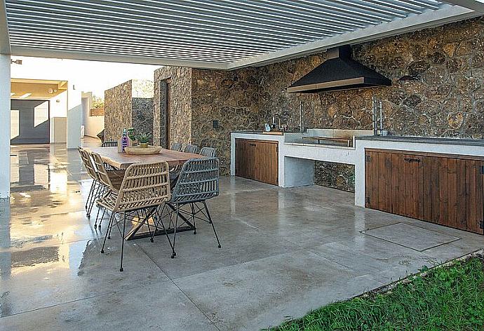 Poolside dining table and BBQ . - Villa Arivallos . (Photo Gallery) }}