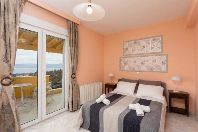 Double bedroom on first floor with A/C, TV, sea views, and balcony access . - Villa Marafen . (Photo Gallery) }}