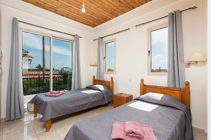 Twin bedroom with A/C and balcony access . - Villa Aristotle . (Галерея фотографий) }}