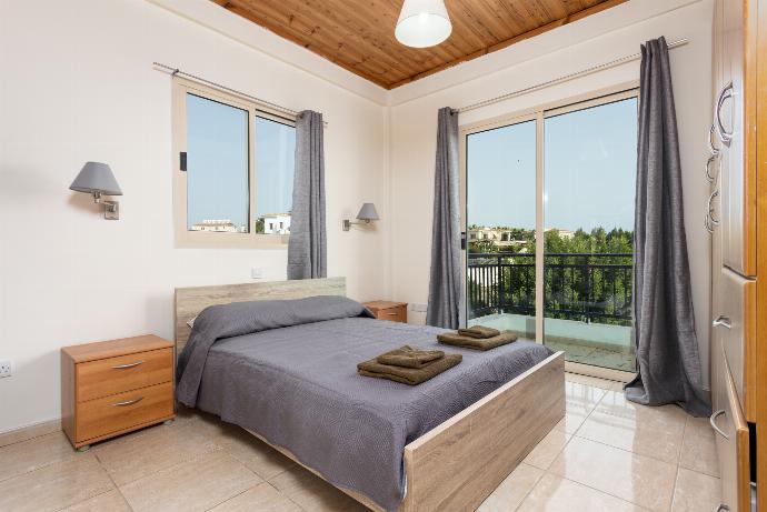 Double bedroom with en suite bathroom, A/C, and balcony access . - Villa Homer . (Photo Gallery) }}