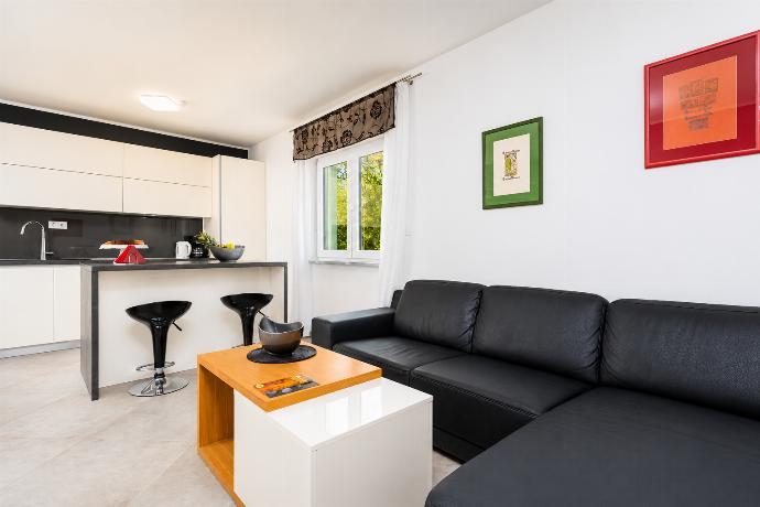 Open-plan living room with sofa, dining area, kitchen, A/C, WiFi internet, and satellite TV . - Villa Krnica . (Photo Gallery) }}