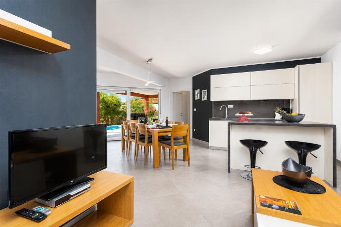 Open-plan living room with sofa, dining area, kitchen, A/C, WiFi internet, and satellite TV . - Villa Krnica . (Photo Gallery) }}