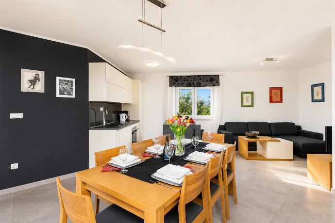 Open-plan living room with sofa, dining area, kitchen, A/C, WiFi internet, and satellite TV . - Villa Krnica . (Photo Gallery) }}