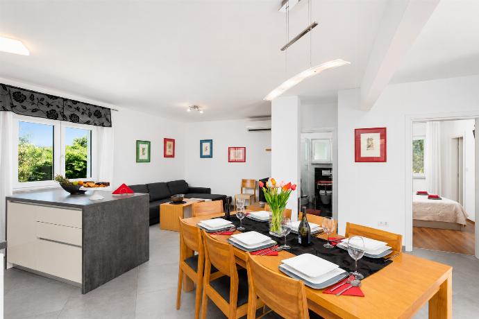 Open-plan living room with sofa, dining area, kitchen, A/C, WiFi internet, and satellite TV . - Villa Krnica . (Photo Gallery) }}